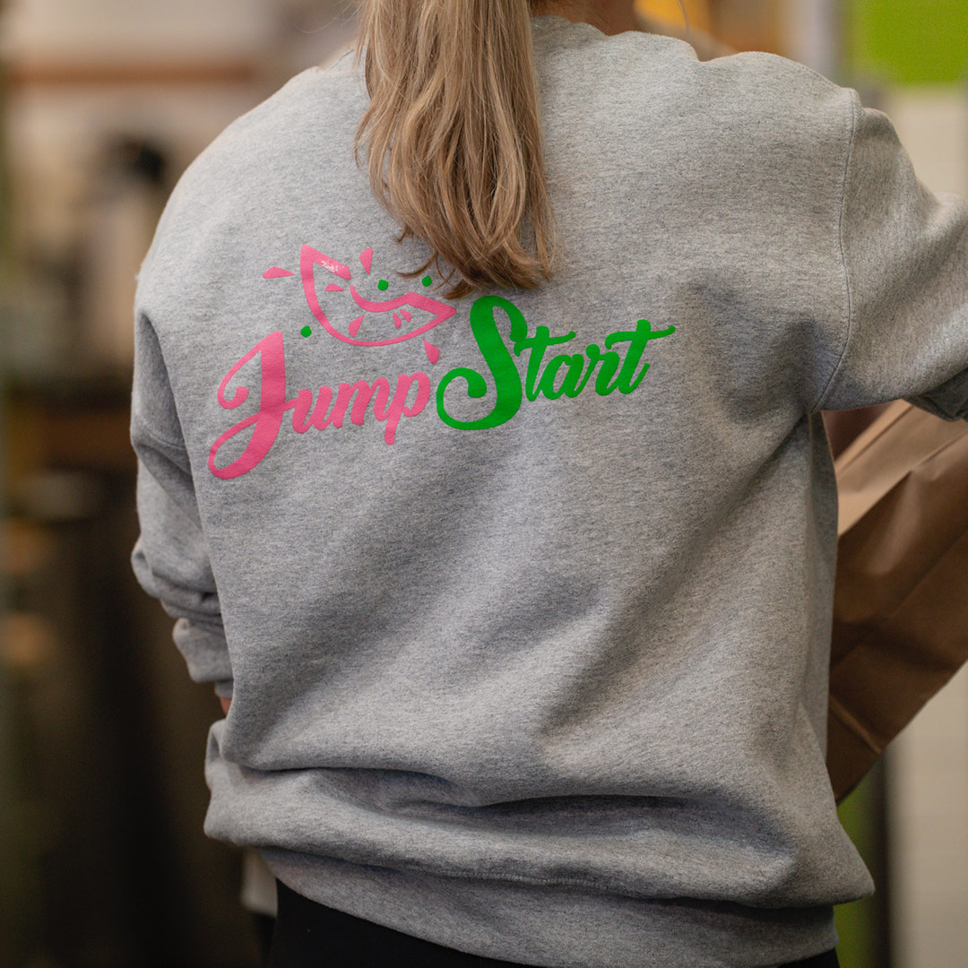 An employee's sweatshirt with the Jump Start Smoothies logo in Lexington, Kentucky.